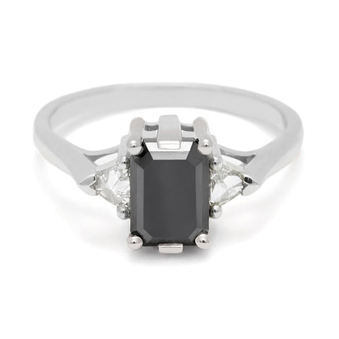 A three stone engagement ring with an emerald cut and emerald shape 7x5mm black diamond center stone with two white diamond trillion side stones set in white gold., White Gold 4