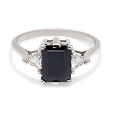 A three stone engagement ring with an emerald cut and emerald shape 8x6mm black diamond center stone with two white diamond trillion side stones set in rose gold., Rose Gold 8