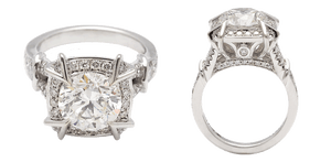 A halo diamond engagement ring set in white gold with a round white diamond center stone and a white diamond halo pave. The ring is pictured here in front facing and from the side.