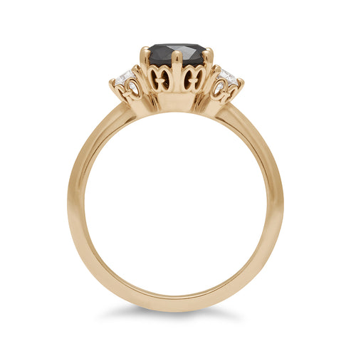 Side view of a three stone engagement ring with a round shape black diamond center stone with two white diamond round side stones set in yellow gold., Yellow Gold