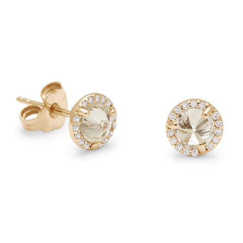 One front angle and one 3/4 angle of two champagne diamond studs featuring a white diamond halo set in yellow gold against a white background. 2