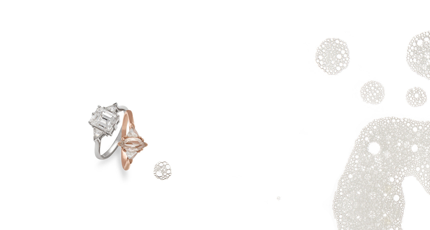 A background image of 2 Bea Three Stone Engagement Rings, one in white gold and white diamonds, the other in rose gold and champagne diamond center, surrounded by bubbles.
