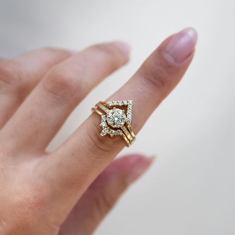 A band with 9 round white diamonds set in yellow gold above a solitaire white diamond engagment ring and a marquise white diamond band. Available in Rose Gold, Yellow Gold, White Gold. 4