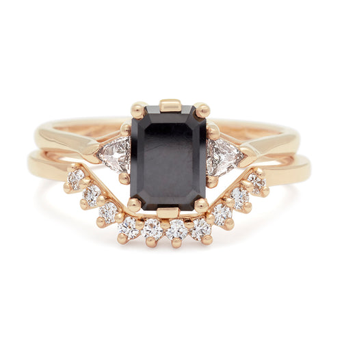 A three stone engagement ring with an emerald cut and emerald shape 7x5mm black diamond center stone with two white diamond trillion side stones set in yellow gold set above a white diamond nesting band., White Gold, Rose Gold, Yellow Gold