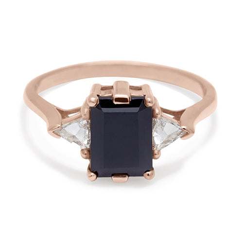 A three stone engagement ring with an emerald cut and emerald shape 8x6mm black diamond center stone with two white diamond trillion side stones set in rose gold., Rose Gold