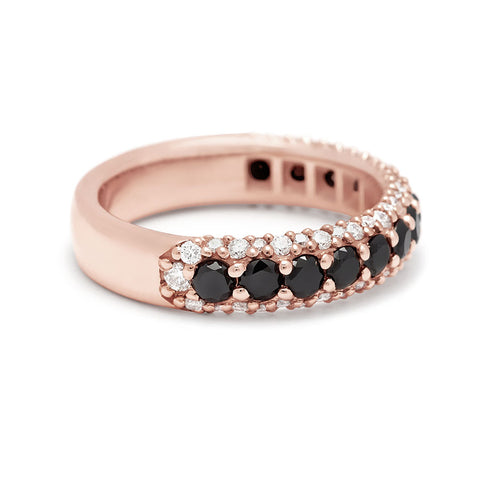 Angled view of a band with round black diamonds in a 3/4 pave around a rose gold band with white diamond accents on both top and bottom. 2