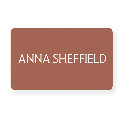 "Anna Sheffield" gift card on a adobe orange color rectangle.