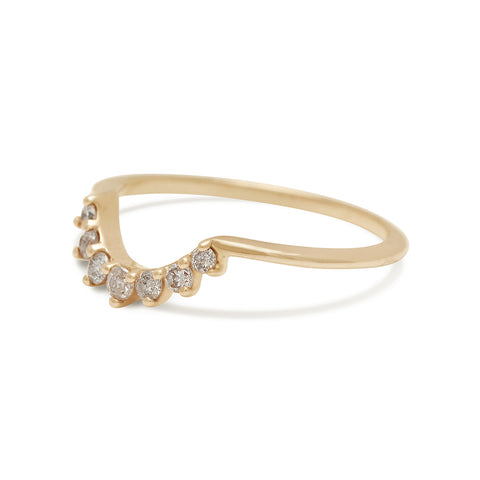 Angled view of a curve band with 7 grey diamonds set in yellow gold. 3