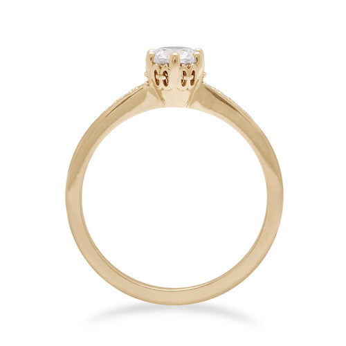Side view of a solitaire ring with a round brilliant cut 0.50ct white diamond with white diamond pave on either side set in yellow gold., Yellow Gold