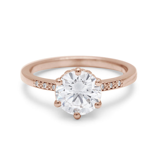 A solitaire ring with a round brilliant cut 1.50ct white diamond with white diamond pave on either side set in rose gold., Rose Gold