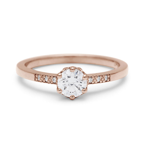 A solitaire ring with a round brilliant cut 0.50ct white diamond with white diamond pave on either side set in rose gold., Rose Gold