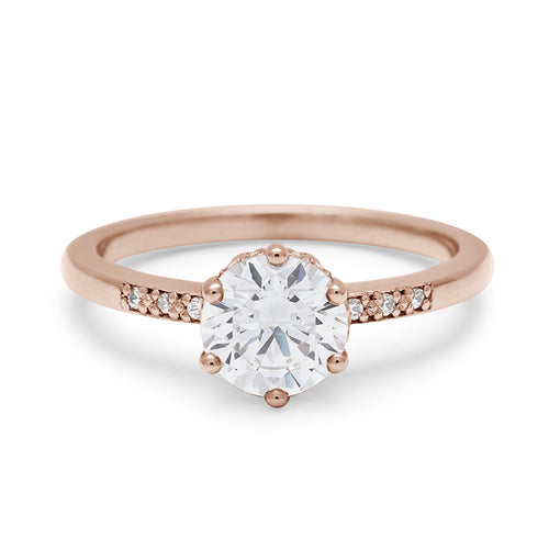 A solitaire ring with a round shape 1.00ct white diamond with white diamond pave on either side set in rose gold., Rose Gold