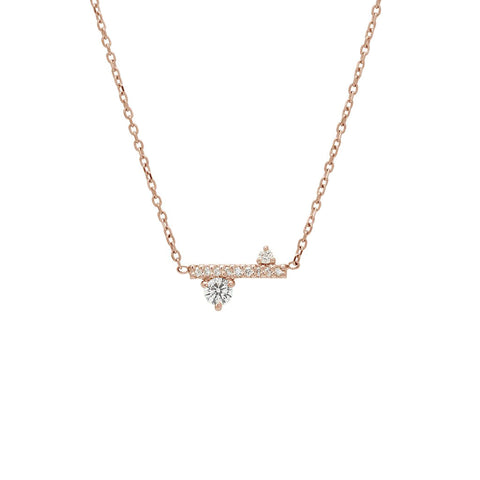 A straight line of white diamond pave with white diamond accent stones on either side set in a rose gold necklace chain., Rose Gold 3
