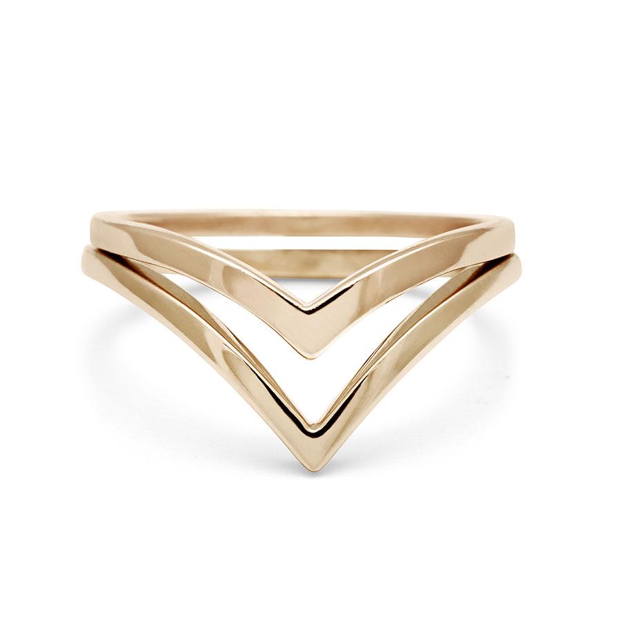 Two solid gold nesting bands one that is chrysalis shaped both in yellow gold.