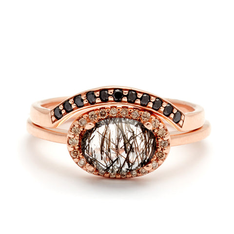 An oval shaped black rutilated quartz ring in a champagne diamond halo set below a curved black diamond band both in rose gold., White Gold, Rose Gold, Yellow Gold 6