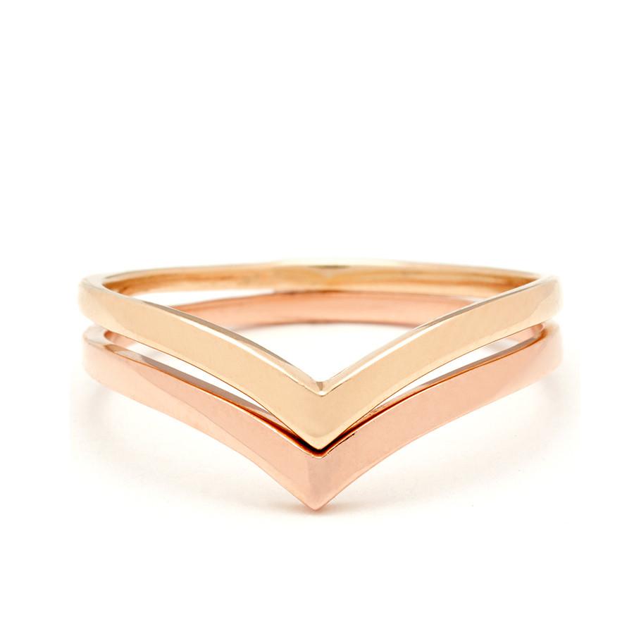 Two solid gold nesting bands in yellow and rose gold.