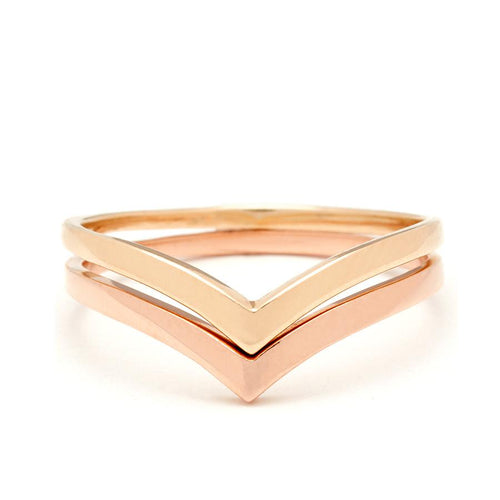 Two solid gold nesting bands in yellow and rose gold.