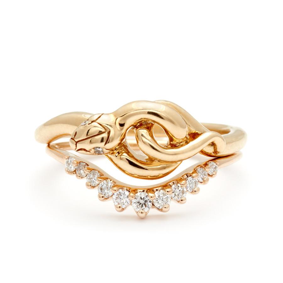 A serpent band with two white diamonds for eyes stacked above an 11 white diamond curve band.