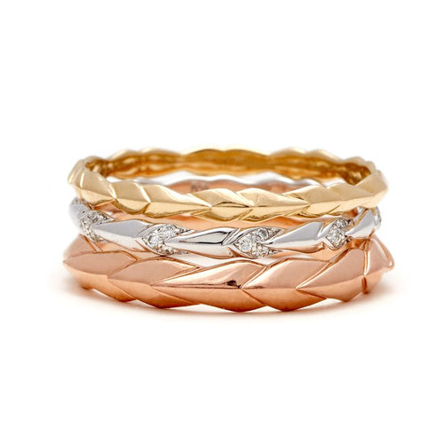 Three straight bands with leaf like definition one with white diamond accent stones.