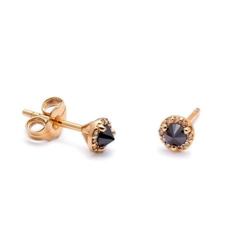 A single tiny black diamond center stone earring with a halo of champagne diamond set in yellow gold. 4