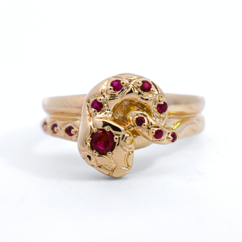 A yellow gold ring in the shape of a serpent encrusted with rubies. 