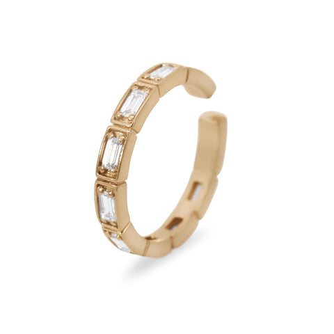 An ear cuff featuring white baguette diamonds set in 14kt yellow gold.