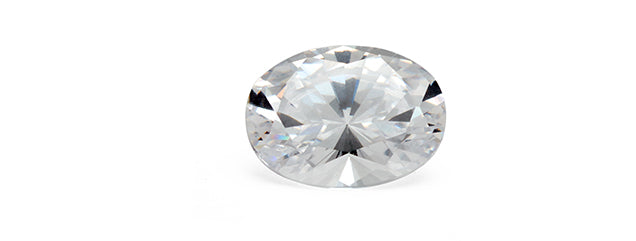 A close up image of a white diamond cut into an oval shape.