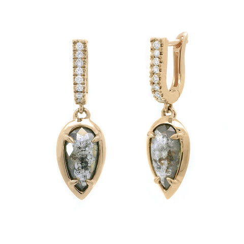 A pair of drop earrings with a U shaped hoop with white diamond pave and a pear shaped grey diamond set in yellow gold one earring angled.