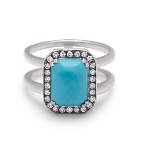 A double banded engagement ring with a emerald shape turquoise surrounded by a white diamond halo set in platinum.
