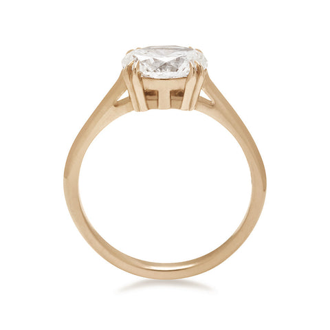 A side view of an east/west solitaire ring with an oval brilliant cut white diamond stone set in yellow gold. 2