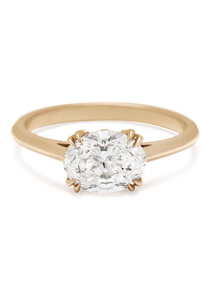 An east/west solitaire ring with an oval brilliant cut white diamond stone set in yellow gold.