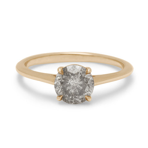A solitaire 1.00ct round grey diamond set in yellow gold.