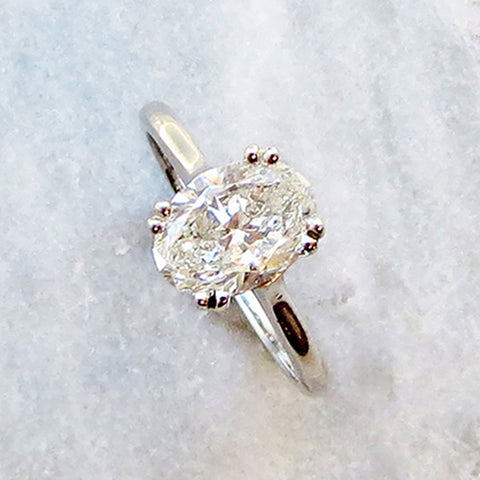 A solitaire ring oval white diamond set in white gold 