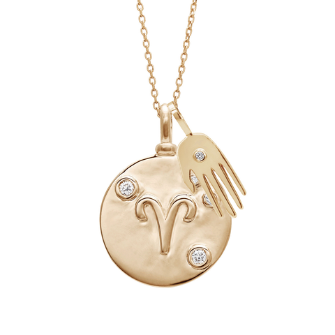 A 18mm charm with the Aries zodiac sign set in yellow gold with white diamond stones on a yellow gold chain with a solid gold hand charm with a white diamond accent., Aries