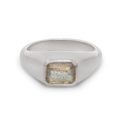 Silver ring with a rectangular stone on a white background