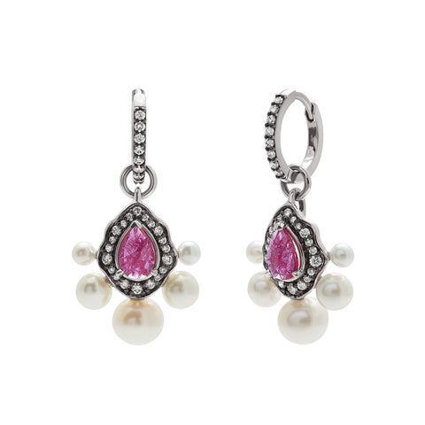 A pair of drop hoops with a pear ruby surrounded by a white diamond halo with 5 pearls at the bottom of the charm set in white gold.