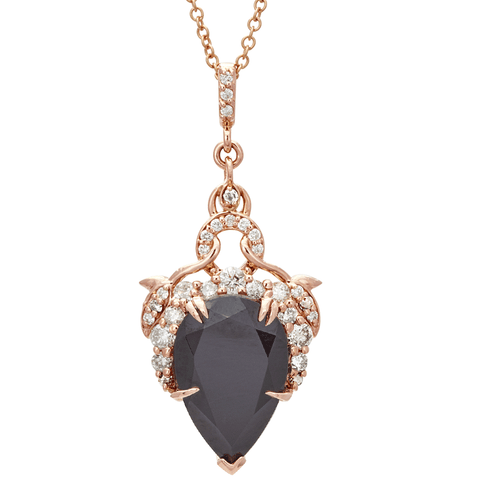 Rose gold necklace with a black teardrop pendant on a white background