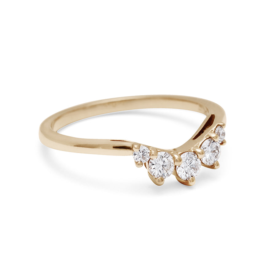 Angled view of a curved 5 white diamond band set in yellow gold.