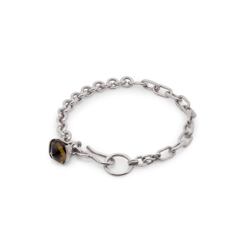 Silver chain bracelet with a cushion cut brown quartz gemstone on a white background