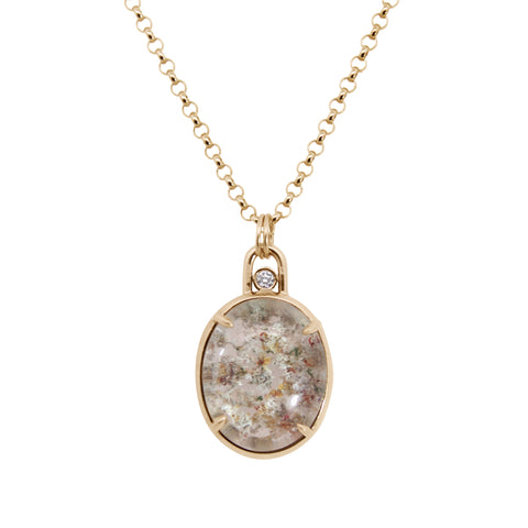 Gold necklace with a pendant featuring a natural stone design on a white background
