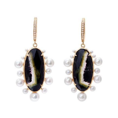 A pair of drop hoops with an oval tourmaline stone surrounded by pearls with white diamond pave on the hoop at the top set in yellow gold.