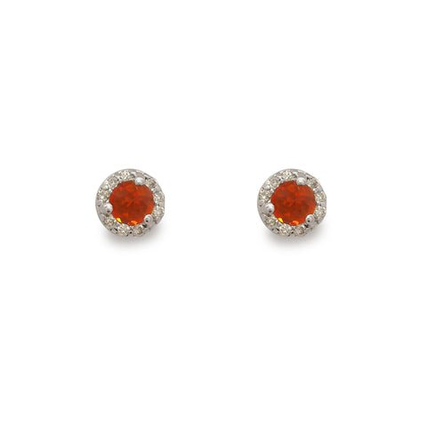 Pair of round earrings with orange gemstones on a white background
