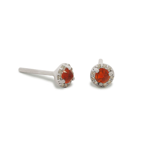 Pair of silver earrings with red gemstones on a white background 3