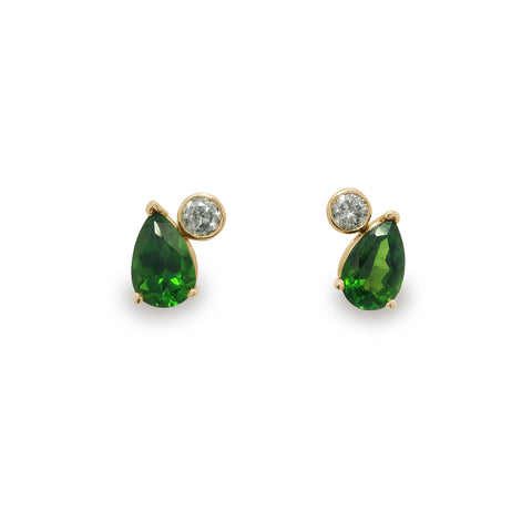 Pair of green pear cut chrome diopside stud earrings with round grey diamonds set in yellow gold on a white background