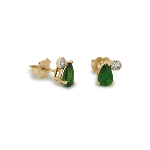 Pair of green pear cut chrome diopside stud earrings with round grey diamonds set in yellow gold on a white background 2