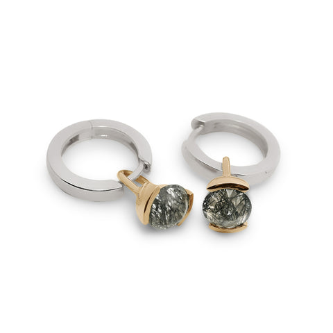 Pair of silver hoop earrings with gold drop details featuring inverted black rutile quartz on a white background 4