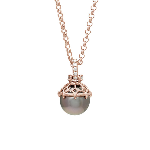 A one of a kind peacock pearl pendant with white diamond pave on the top and grey diamond accent stones on either side on a rose gold chain.