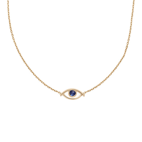 A choker with an evil eye charm with a blue sapphire stone in the center set on a yellow gold chain.