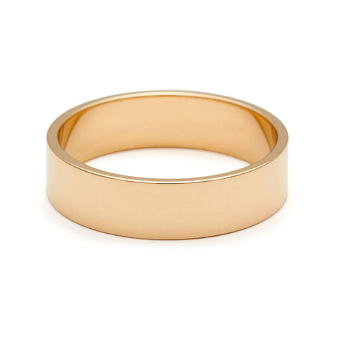 A 5mm flat band set in yellow gold. 6