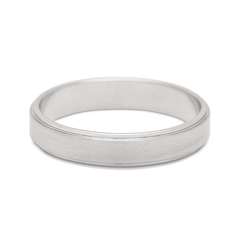 A 4mm flat edge band with a brushed finish set in white gold. 4